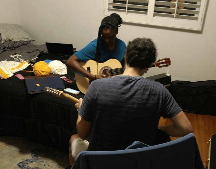 Katria and James working on Katria's poor guitar skills